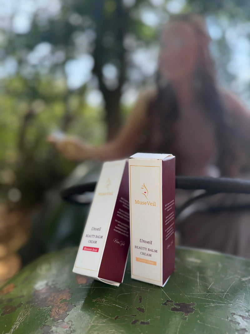 Two boxes of Utsuel Beauty Balm Cream by MuneVeil placed on a green metal surface, with a blurred outdoor scene and a person in the background.