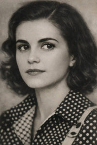 Black and white portrait of a woman wearing a polka dot blouse.