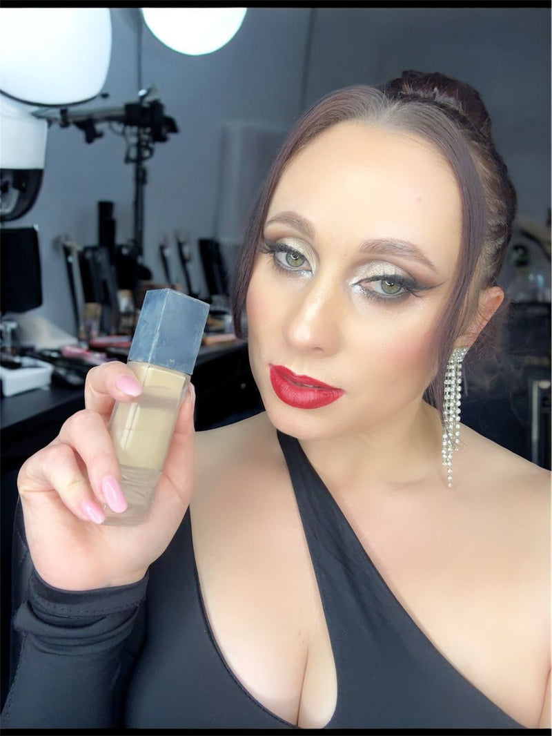 Woman holding a makeup product in a professional setting
